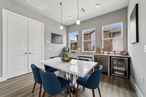 Gunter apartment for rent - A dining room with a white table and blue chairs.