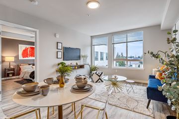 Shoreline apartment for rent - a living room with a table and chairs and a tv