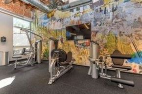 Tucson apartment for rent - A gym with a variety of equipment including a treadmill, weights, and a bench press.