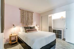 San Diego apartment for rent - A bedroom with a bed, nightstand, and a window with curtains.