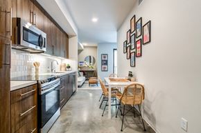 San Diego apartment for rent - A modern kitchen with a dining table and chairs.