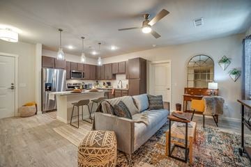 Lewisville apartment for rent - a living room with a couch in front of a kitchen