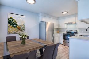 Bend apartment for rent - Oasis at 2600 A kitchen with a dining table and chairs.