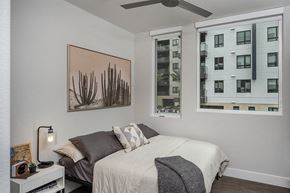 Oakland apartment for rent - a bedroom with a bed and two windows