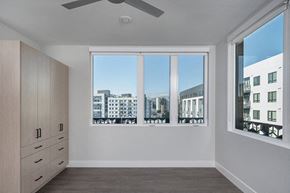 Oakland apartment for rent - a bedroom with a large window and a dresser