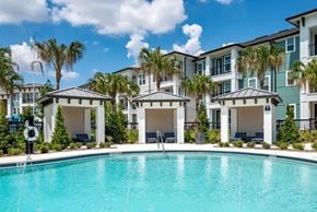 Winter Garden apartment for rent - A swimming pool in front of a row of apartment buildings.