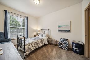 Richland apartment for rent - A bedroom with two beds and a chair.