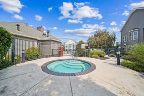 Richland apartment for rent - A small pool surrounded by a fence and a walkway.