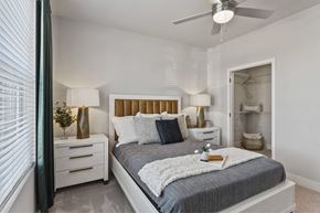 Colorado Springs apartment for rent - A bedroom with a bed, nightstands, and a ceiling fan.