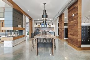 Lees Summit apartment for rent - the kitchen has a large island with a wooden table and chairs