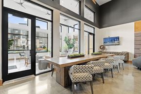 Lees Summit apartment for rent - a dining room with a long wooden table and chairs
