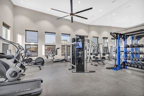 Grand Prairie apartment for rent - A spacious gym with a variety of equipment including treadmills, elliptical machines, and weight racks.