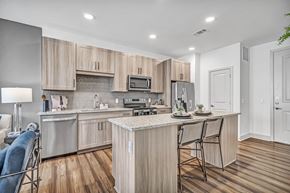 Grand Prairie apartment for rent - A modern kitchen with wooden cabinets and a central island.