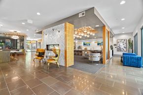 San Antonio apartment for rent - A spacious lobby with a variety of seating options and a large chandelier.