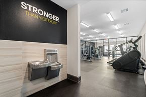 Austin apartment for rent - A gym with a wall that says "STRONGER THAN YESTERDAY" and a treadmill in the background.