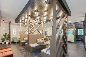 Charlotte apartment for rent - Axis at the Park clubhouse with booth seating and overhead lighting