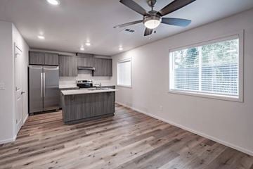 Vancouver apartment for rent - A modern kitchen with wooden floors and a ceiling fan.