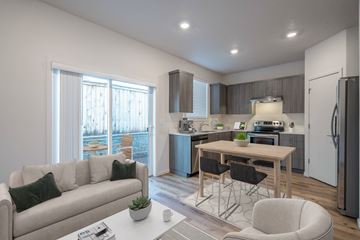 Vancouver apartment for rent - A modern kitchen and living room with a dining table and chairs.