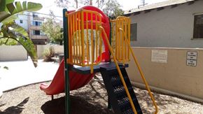San Diego apartment for rent - A red slide with a yellow ladder in a playground.