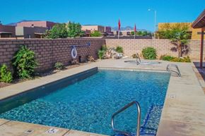 Sierra Vista apartment for rent - A swimming pool surrounded by a wall and some plants.