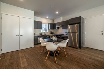 Wenatchee apartment for rent - A modern kitchen with a dining table and chairs.