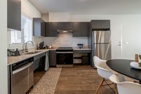 Wenatchee apartment for rent - A modern kitchen with a stainless steel refrigerator, oven, and sink.