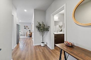 Post Falls apartment for rent - A modern kitchen with a dining table and a potted plant.