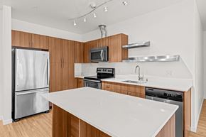 Seattle apartment for rent - a kitchen with a white counter top and a stainless steel refrigerator