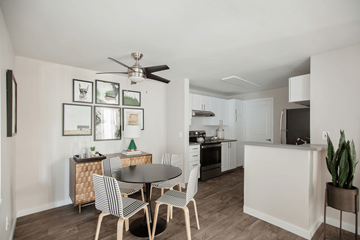 Tualatin apartment for rent - A modern kitchen with a dining table set for four.