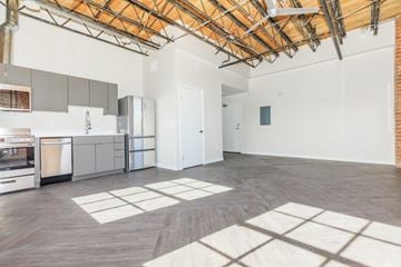 Tucson apartment for rent - A kitchen with a dining table and a refrigerator.