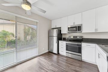San Diego apartment for rent - A kitchen with white cabinets and a stainless steel refrigerator.