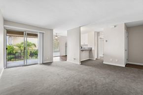 San Diego apartment for rent - A spacious living room with a sliding glass door leading to a backyard.