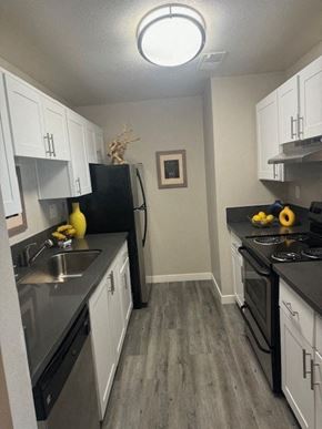 Santa Rosa apartment for rent - a kitchen with white cabinets and stainless steel appliances
