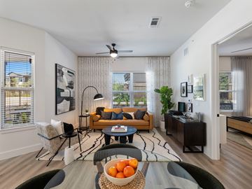 Leander apartment for rent - A living room with a couch, chairs, and a table with oranges on it.
