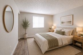 Aloha apartment for rent - A bedroom with a large bed and a small plant on the side table.