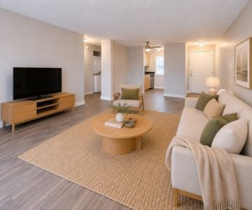 Aloha apartment for rent - A living room with a television, a couch, and a coffee table.