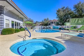 Sierra Vista apartment for rent - A swimming pool with a slide and a building in the background.