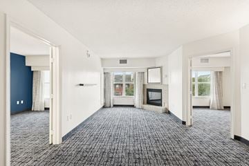 Houston apartment for rent - A spacious living room with a television and a fireplace.