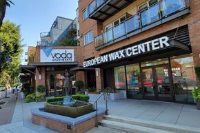 Kirkland apartment for rent - a large brick building with a sign that reads vodafone european wax center