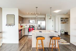 Chicago apartment for rent - a kitchen with an island and three stools in front of a counter top