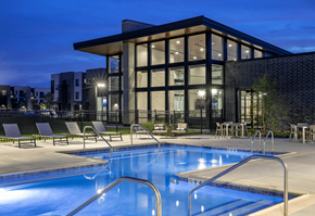 Warrenville apartment for rent - a swimming pool in front of a building at night