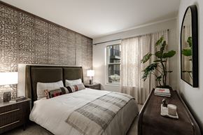 Aurora apartment for rent - A bedroom with a large bed and a wooden headboard.