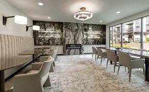 Aurora apartment for rent - A modern dining room with a long table and chairs.