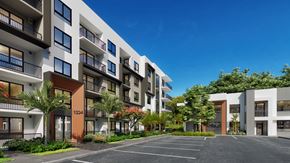 Pompano Beach apartment for rent - A modern apartment complex with a parking lot in front.