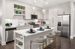 Johns Creek apartment for rent - A modern kitchen with white cabinets and a white island.