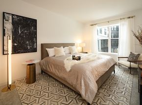 Vernon Hills apartment for rent - a bedroom with a bed and a painting on the wall