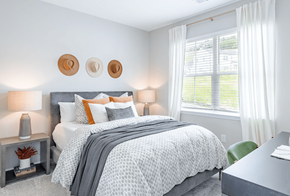 Cartersville apartment for rent - a bedroom with a bed and two windows