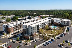 Doraville apartment for rent - an aerial view of an apartment complex with a pool and parking lot