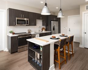 Doraville apartment for rent - a kitchen with a large island with a white counter top