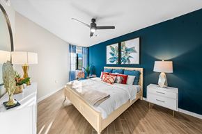 Palmetto Bay apartment for rent - a bedroom with a bed and a blue wall and a ceiling fan